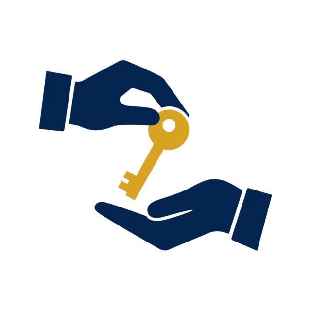 Hands passing a key above a business property for succession planning